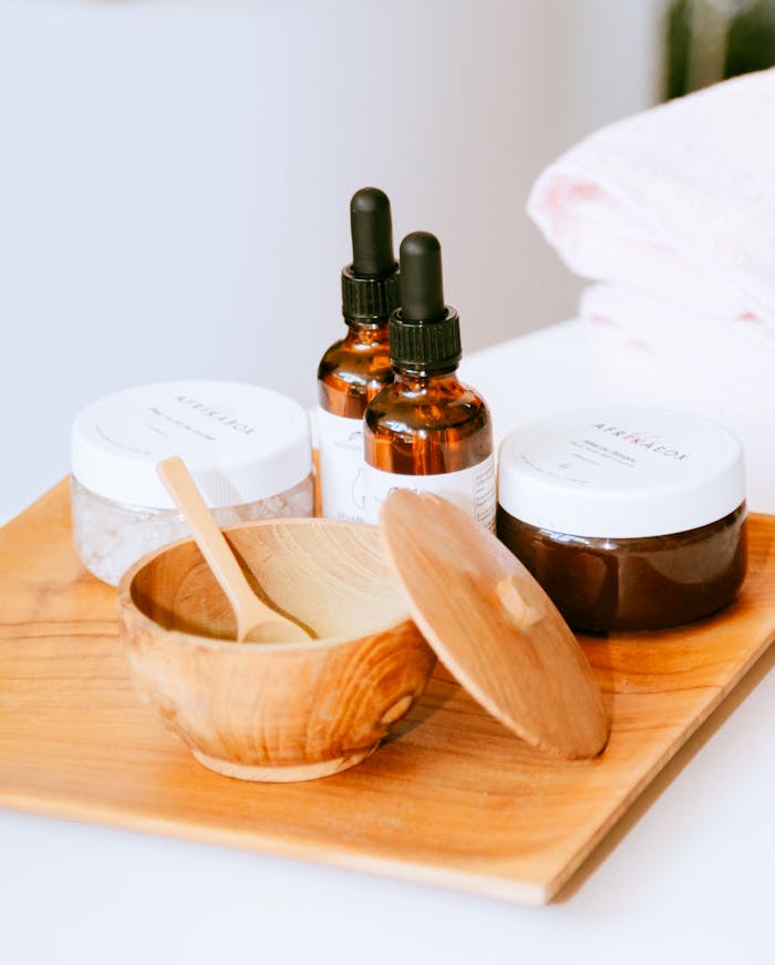 gallery-3 Aesthetic display of natural skincare products on a wooden tray with droppers and jars.