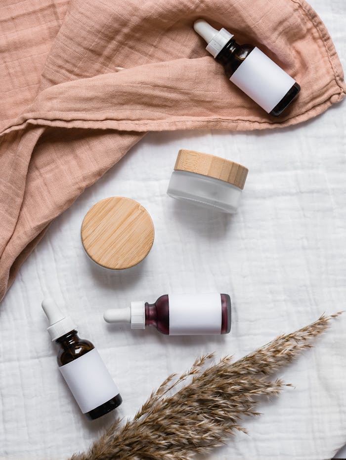 services-01 Stylish flat lay of serum bottles and jars on soft fabric with a natural, earthy aesthetic.